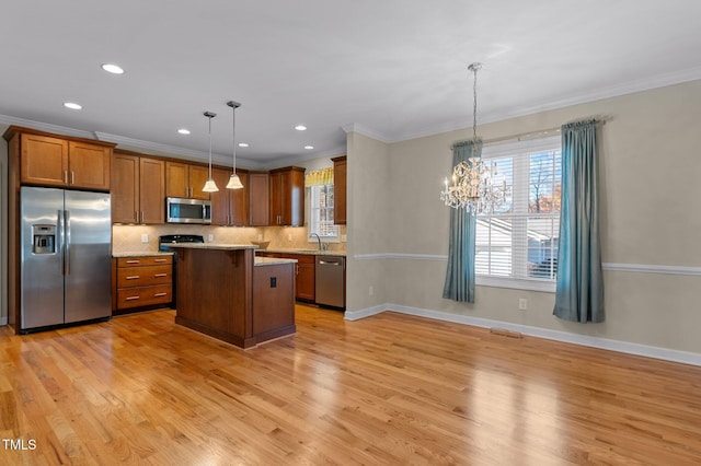 kitchen featuring a center island, hanging light fixtures, an inviting chandelier, light hardwood / wood-style floors, and appliances with stainless steel finishes