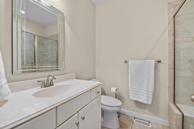 bathroom with tile patterned flooring, vanity, an enclosed shower, and toilet