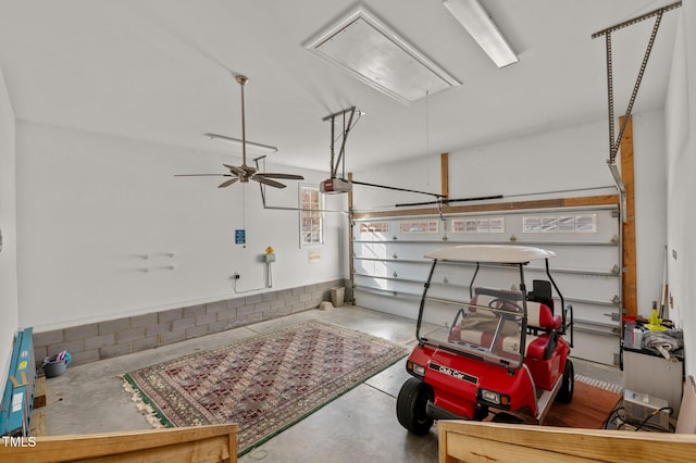 garage featuring ceiling fan and a garage door opener