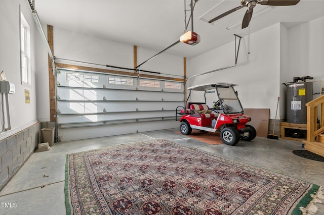 garage with ceiling fan, a garage door opener, and water heater