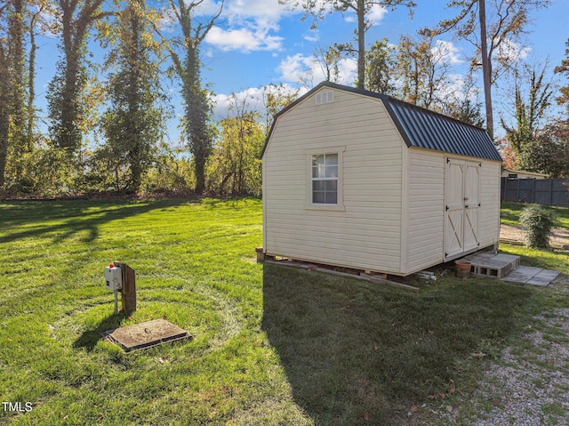 view of outbuilding featuring a yard