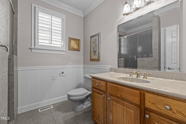 bathroom featuring toilet, ornamental molding, vanity, a shower with door, and tile patterned flooring