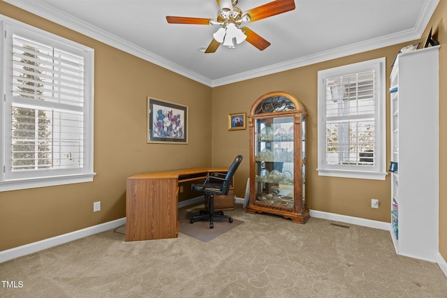 home office featuring light colored carpet, plenty of natural light, ornamental molding, and ceiling fan