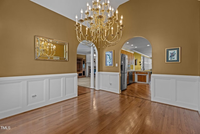 unfurnished dining area with ornamental molding and hardwood / wood-style floors