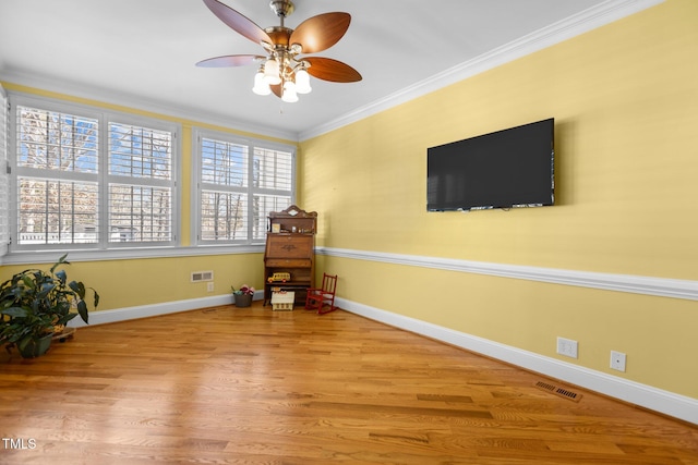 unfurnished room with hardwood / wood-style flooring, ceiling fan, and ornamental molding