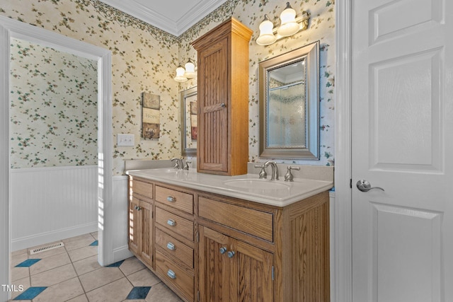 bathroom featuring tile patterned flooring, vanity, and crown molding