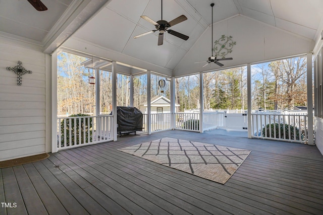 unfurnished sunroom featuring lofted ceiling and ceiling fan