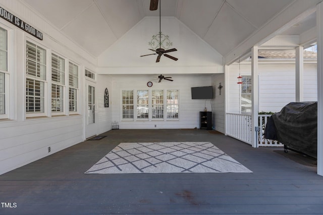 unfurnished sunroom with ceiling fan and lofted ceiling