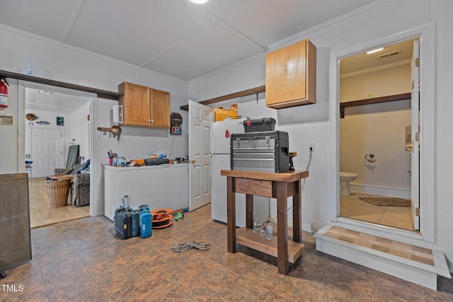 kitchen featuring white refrigerator and ornamental molding