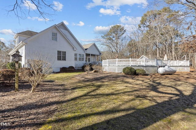 view of side of property with a yard and a deck