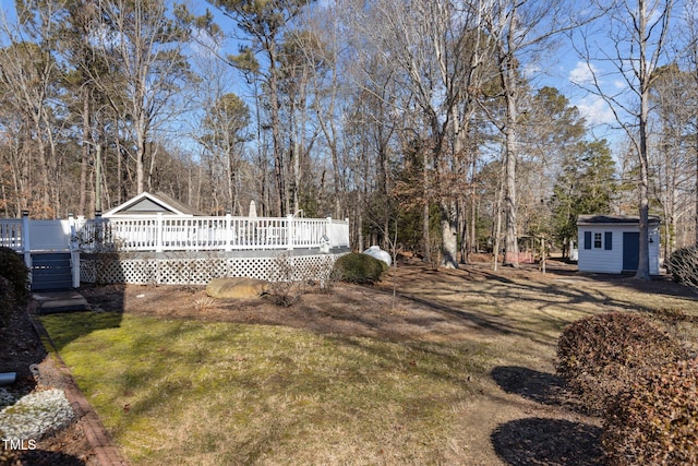 view of yard with a storage shed and a deck