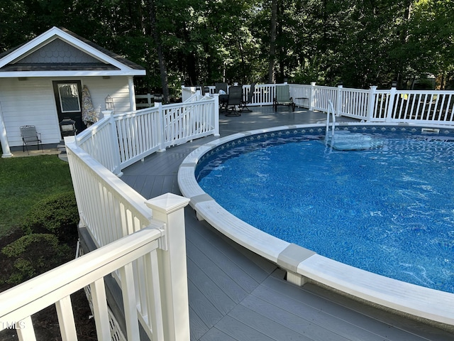 view of swimming pool featuring a deck