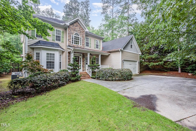 1620 Dunn Rd, Raleigh, NC 27614 - view of front of property with stone siding, driveway, a front lawn, and an attached garage