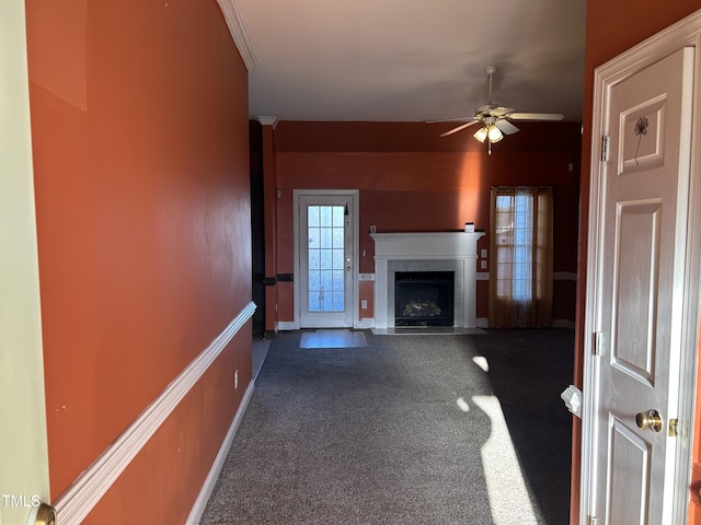 unfurnished living room with dark colored carpet and ceiling fan