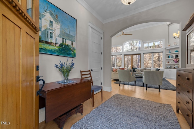 office space featuring ceiling fan, ornamental molding, and light hardwood / wood-style floors