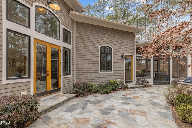 property entrance with a patio and french doors