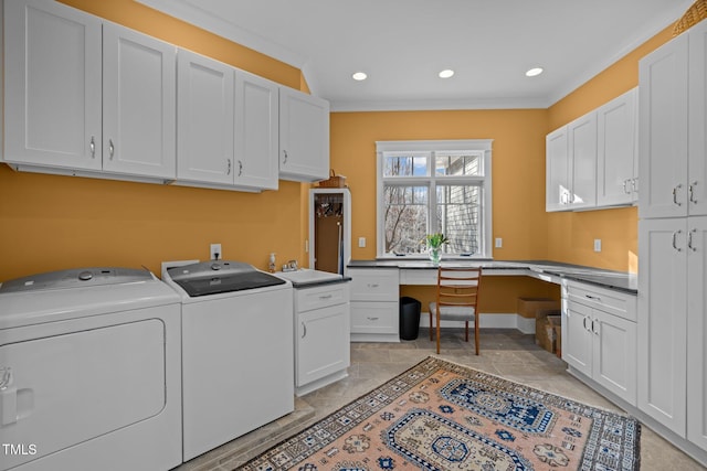 laundry room with independent washer and dryer, sink, ornamental molding, and cabinets