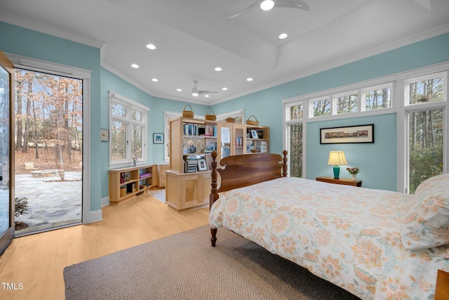 bedroom with crown molding, light wood-type flooring, and access to outside