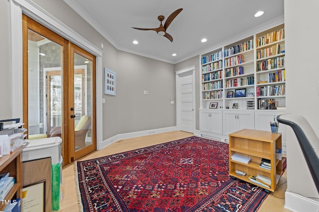 sitting room with light hardwood / wood-style floors, ornamental molding, french doors, and ceiling fan