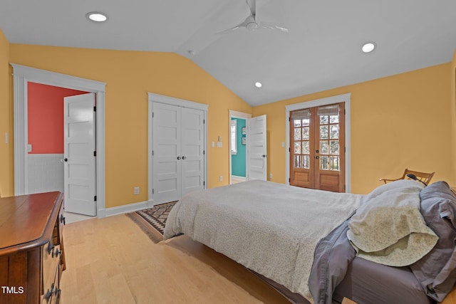 bedroom featuring french doors, vaulted ceiling, and hardwood / wood-style flooring