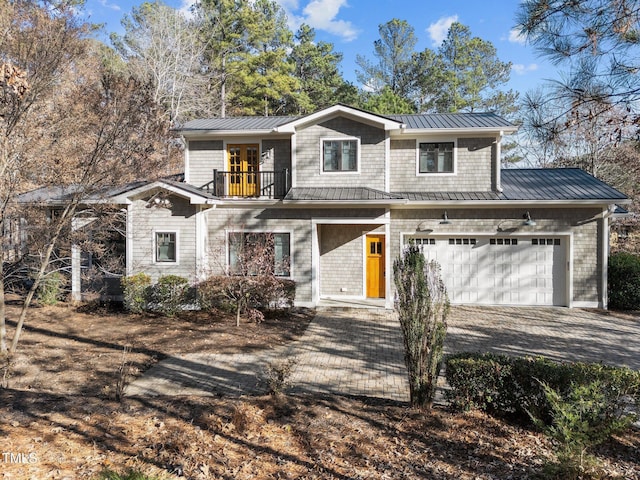 view of front property featuring a balcony and a garage