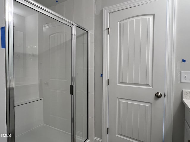 bathroom featuring an enclosed shower and vanity