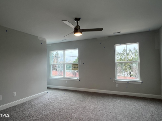 spare room featuring ceiling fan and carpet