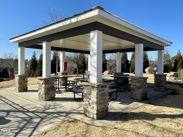 view of property's community featuring a gazebo, outdoor dining space, and a patio area