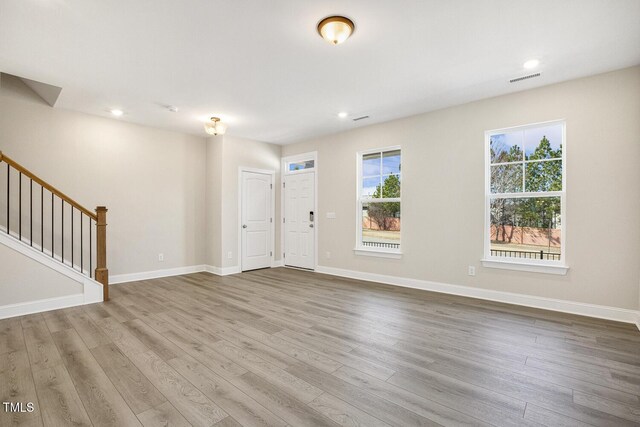 foyer entrance with recessed lighting, wood finished floors, visible vents, baseboards, and stairs