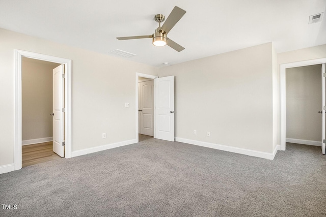 unfurnished bedroom featuring carpet flooring, visible vents, and baseboards