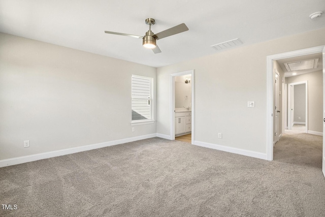 unfurnished bedroom featuring visible vents, light carpet, and baseboards