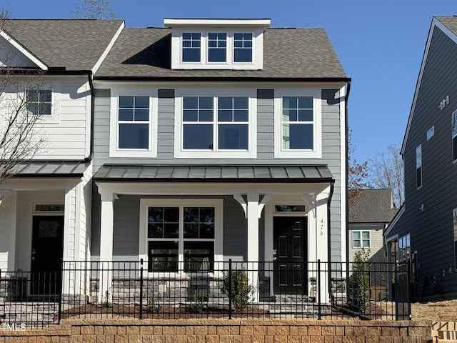 view of front of home with metal roof, a standing seam roof, and a porch