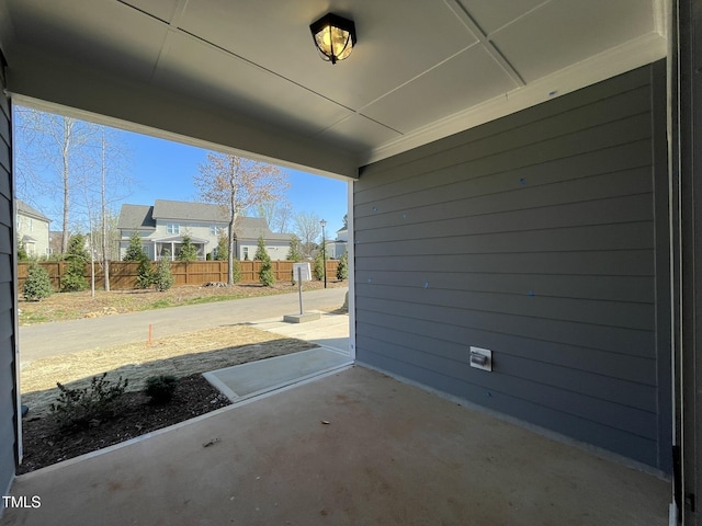 view of patio / terrace with fence and a residential view