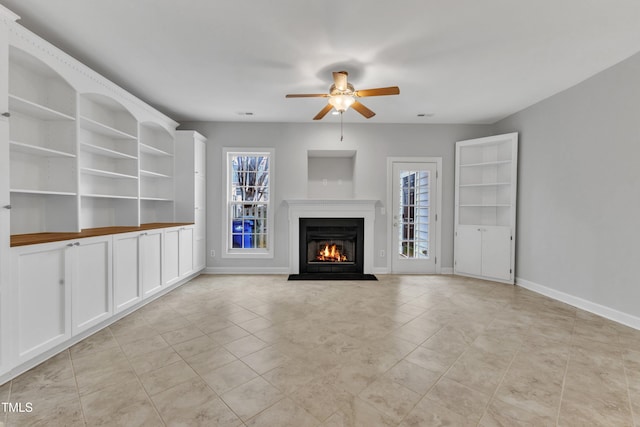 unfurnished living room featuring light tile patterned floors and ceiling fan