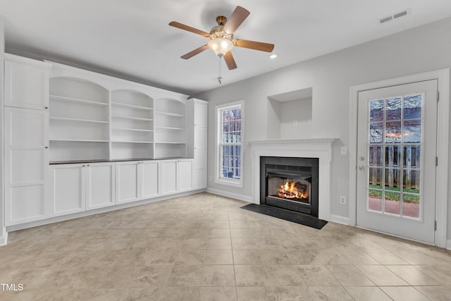 unfurnished living room with ceiling fan and light tile patterned flooring