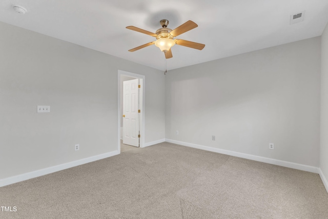 empty room with ceiling fan and light carpet