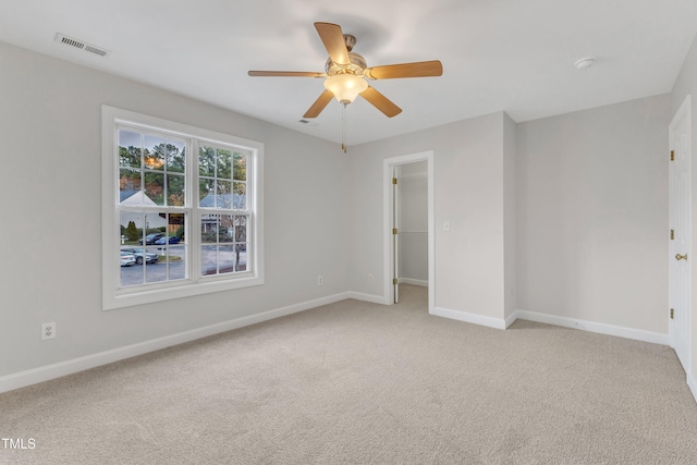 unfurnished room featuring ceiling fan and light carpet