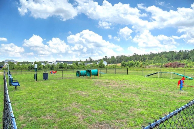 view of home's community featuring a yard and fence