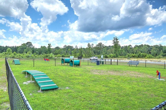 surrounding community featuring a yard, fence, and heating fuel