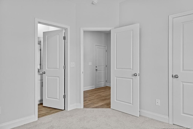 unfurnished bedroom featuring carpet and baseboards