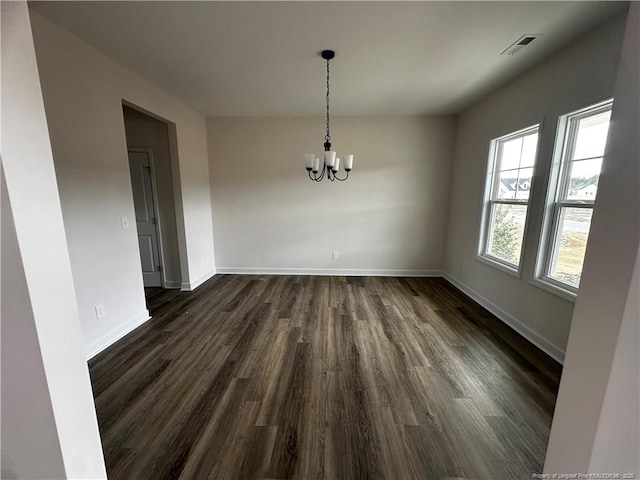 unfurnished dining area with baseboards, visible vents, a chandelier, and dark wood-type flooring