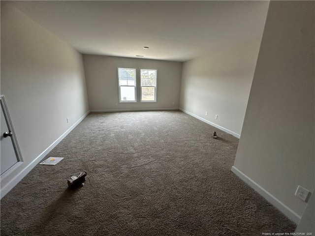 carpeted empty room with baseboards