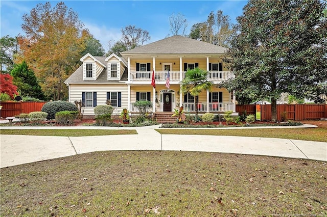 view of front of home with covered porch and a front yard