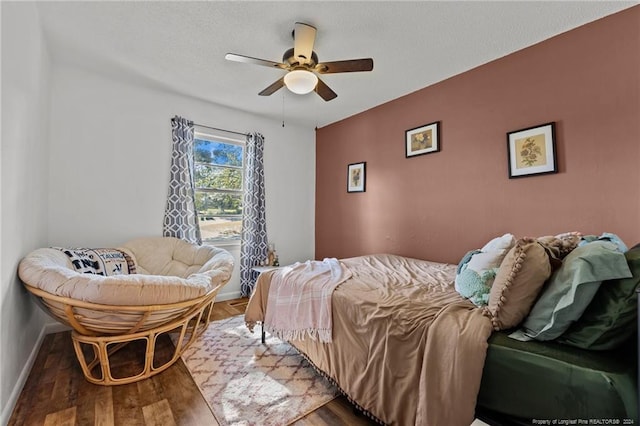 bedroom with ceiling fan and wood-type flooring