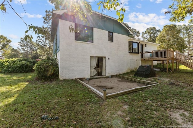 rear view of property featuring a yard and a wooden deck