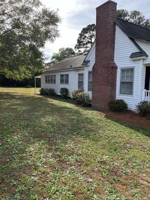 view of side of home featuring a lawn