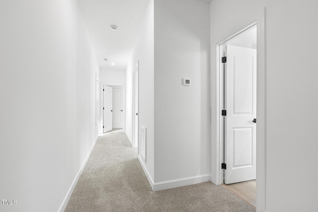 hallway featuring light carpet