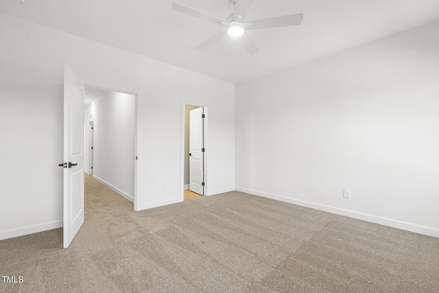 spare room featuring light carpet and ceiling fan