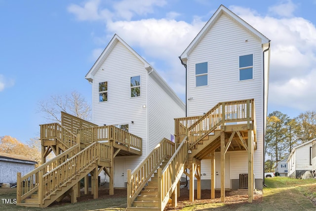 back of property featuring central air condition unit and a deck