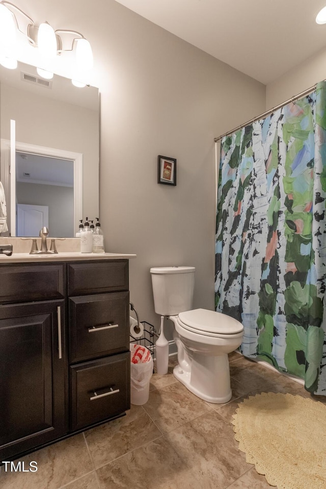 bathroom featuring tile patterned flooring, a shower with curtain, vanity, and toilet